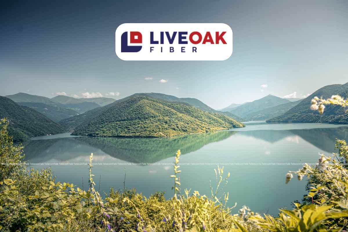 Scenic lake view with LiveOak Fiber logo in mountains