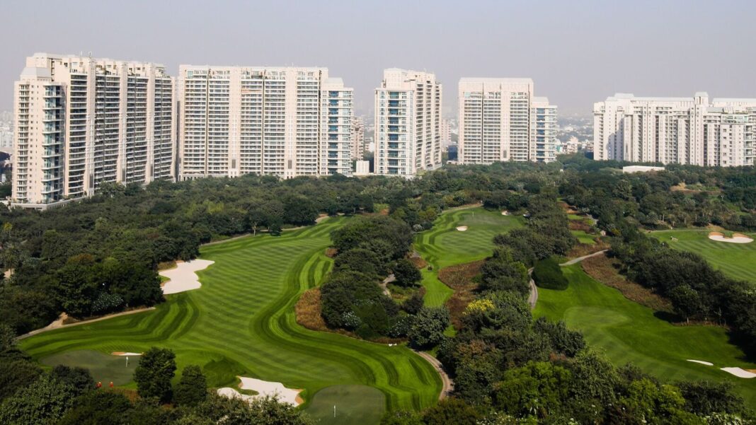 Urban skyline overlooking lush golf course.