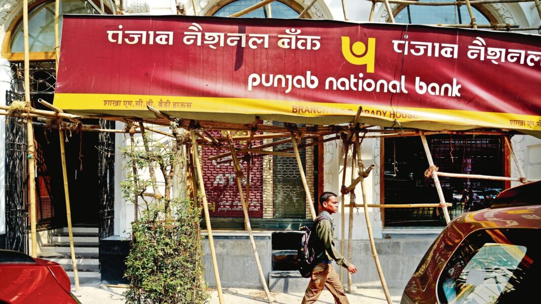 Punjab National Bank signboard with pedestrian in India.