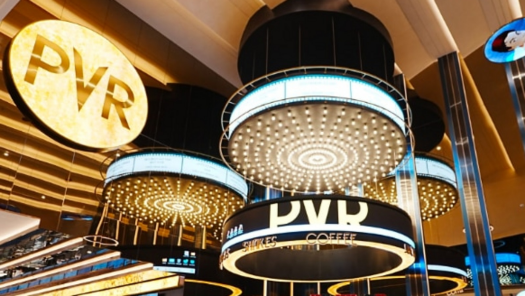 Illuminated movie theater entrance with PVR signage.