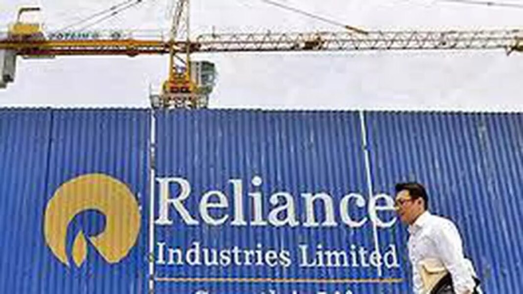 Construction crane over Reliance Industries sign.