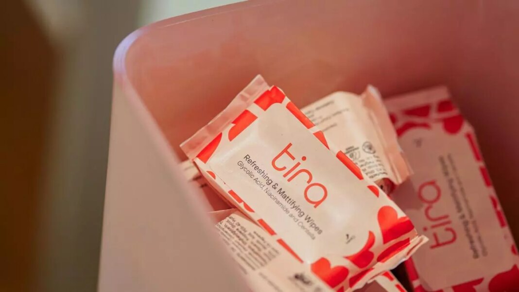 Packets of "tina" refreshing wipes in container.