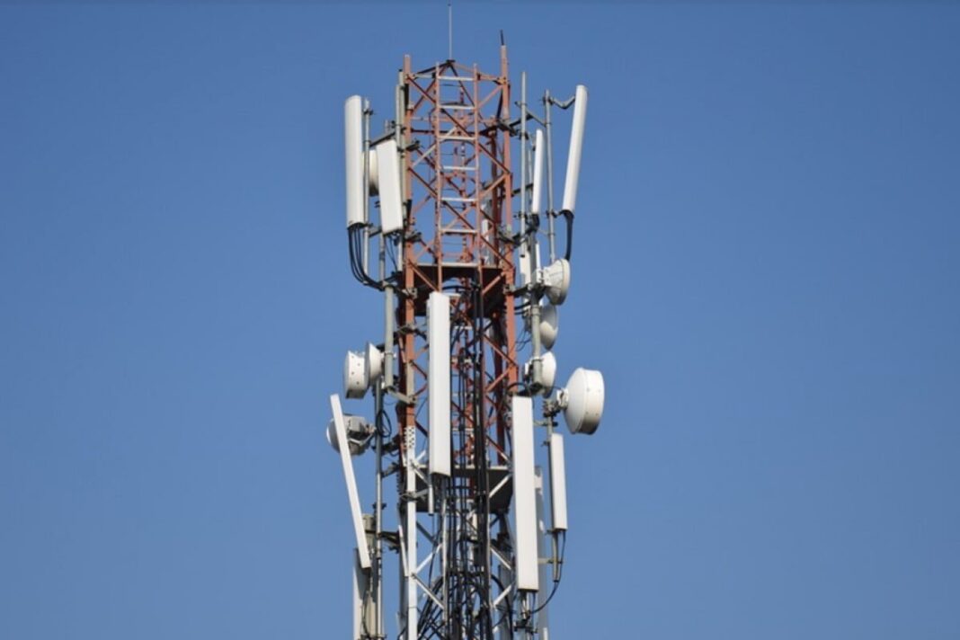 Cellular tower with antennas against blue sky
