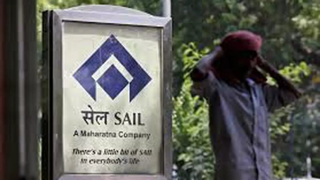 SAIL company signboard and passing pedestrian in background.