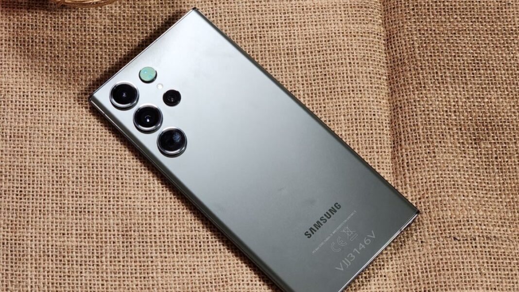 Samsung smartphone with multiple cameras on textured background.
