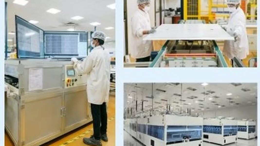 Technicians working in cleanroom semiconductor manufacturing facility.