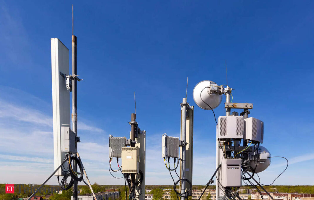Cellular network towers and equipment against blue sky.