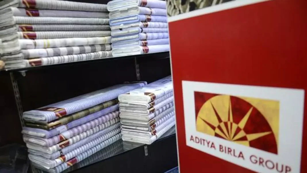 Stacked textiles near Aditya Birla Group logo.