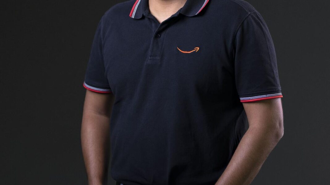 Man in black polo shirt with logo.