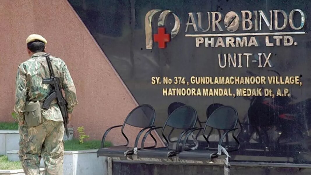 Guard standing outside Aurobindo Pharma facility.