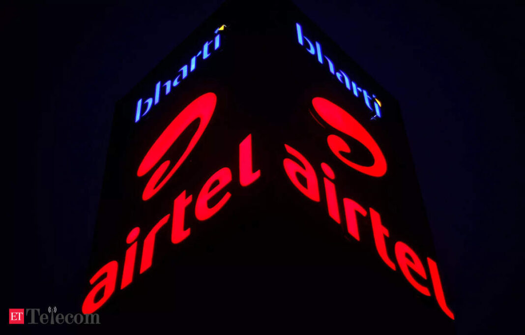 Illuminated telecom company signage at night.