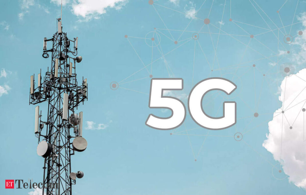 Cellular tower with 5G technology logo against sky.