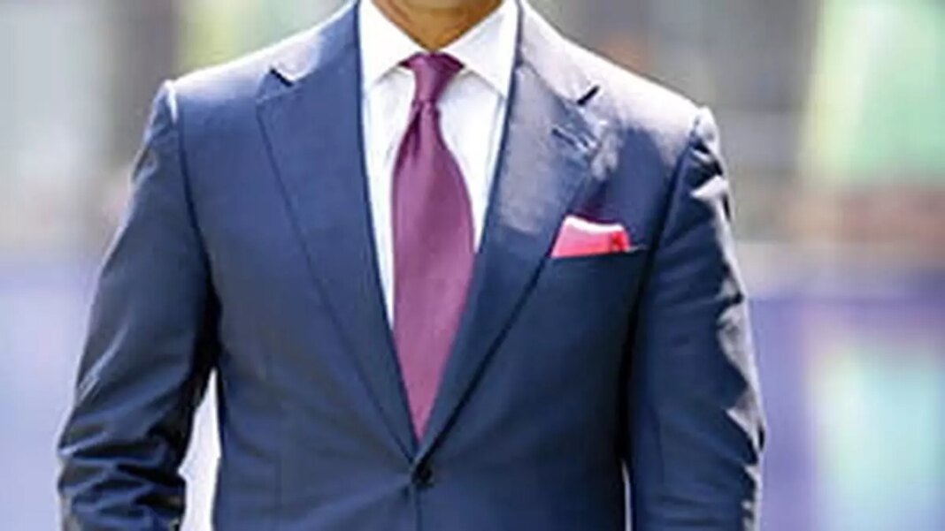 Man in stylish blue suit with pink tie.