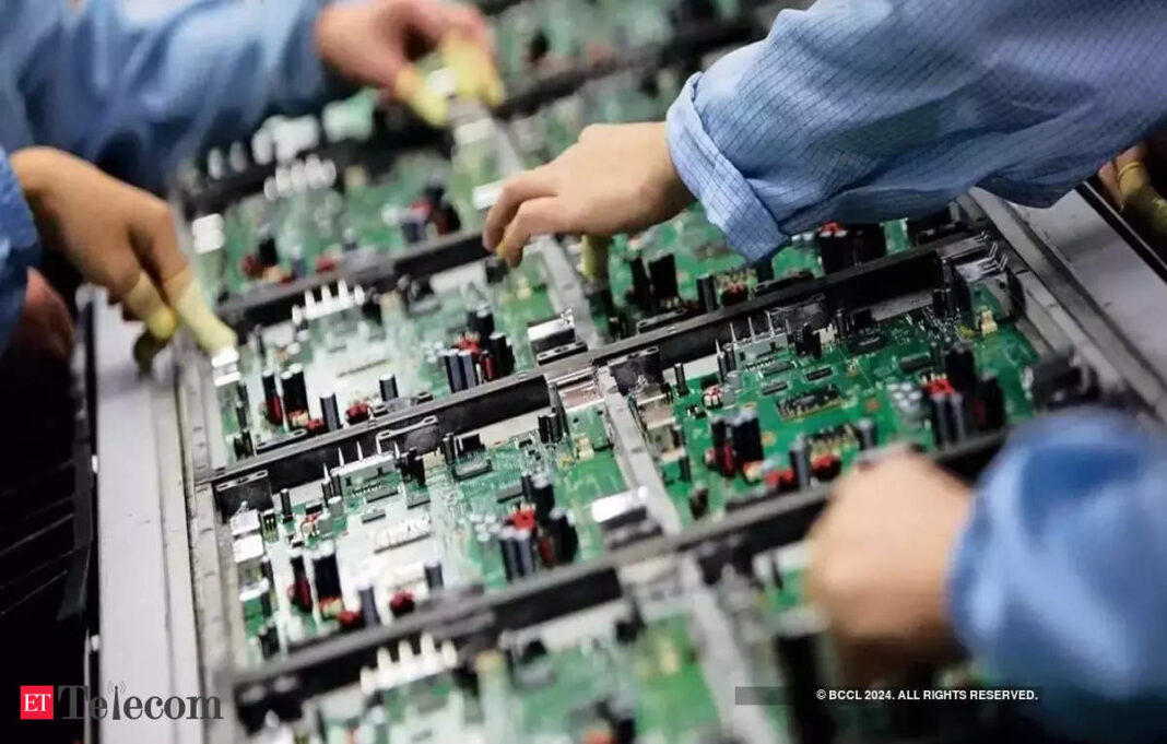 Technicians assembling electronic circuit boards.