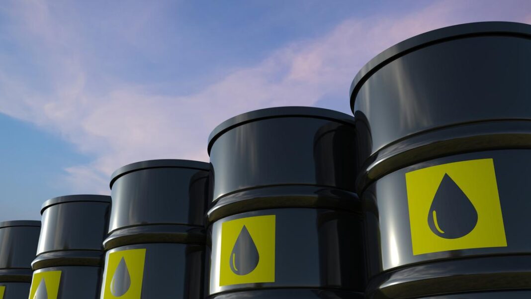 Oil barrels stacked against sky background.