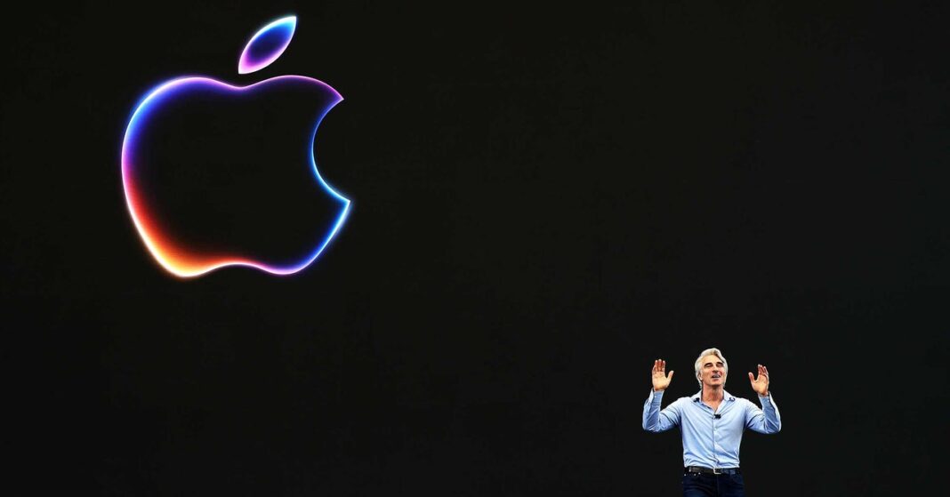Person presenting under colorful Apple logo.