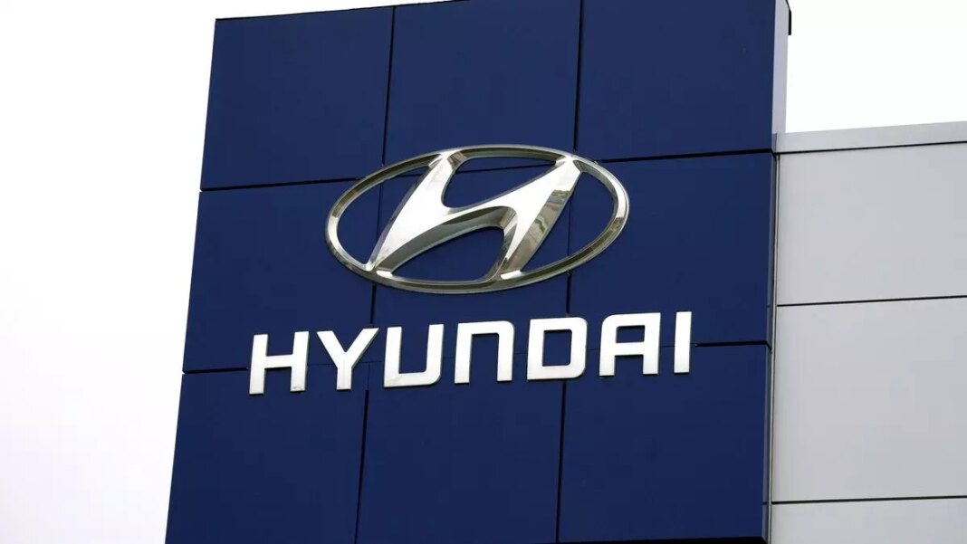 Hyundai logo on dealership building facade.