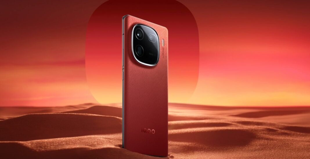 Red smartphone on desert-like surface at sunset.