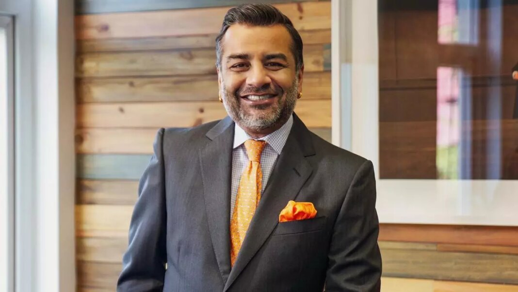 Smiling businessman in suit with orange tie and pocket square