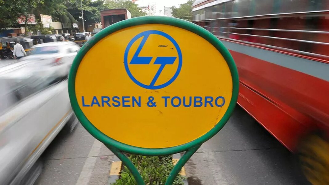 Larsen & Toubro signboard with blurred traffic background.