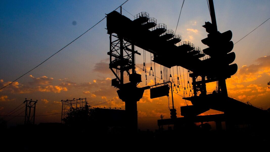 Silhouette of electrical substation at sunset.