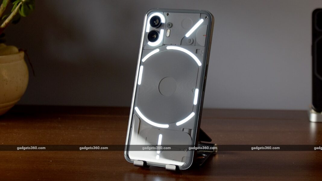 Smartphone with illuminated clear case on desk.