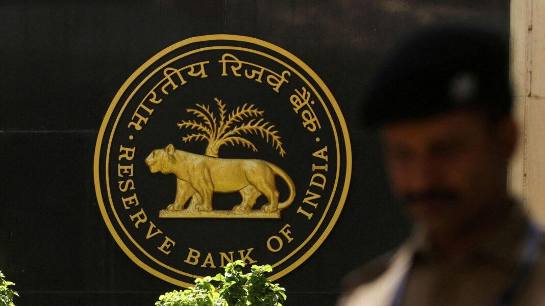 Reserve Bank of India emblem with security guard passing.