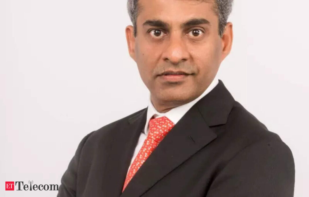 Man in suit with red tie for professional headshot.