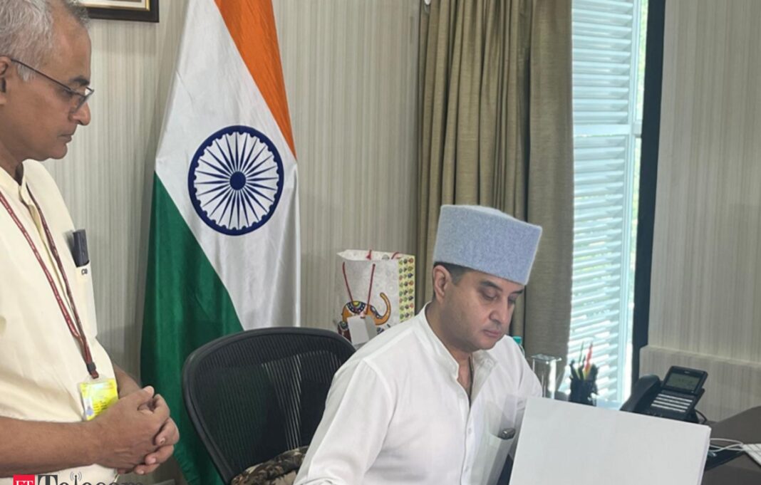 Two men working in office with Indian flag.