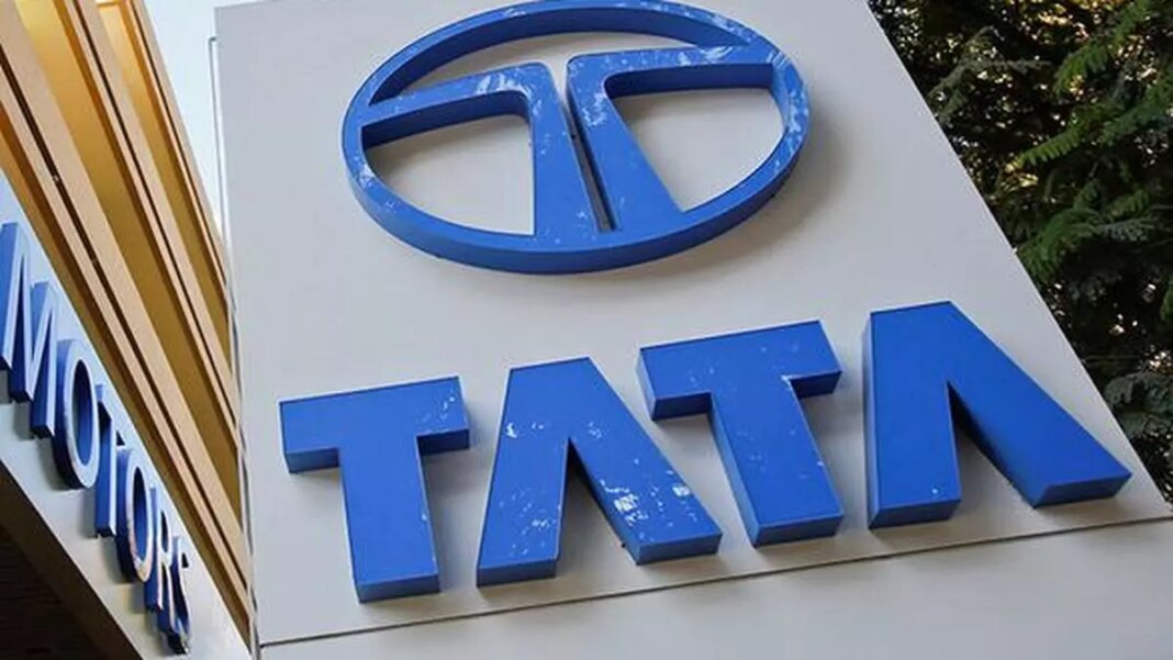 Tata Motors company logo sign on building exterior.