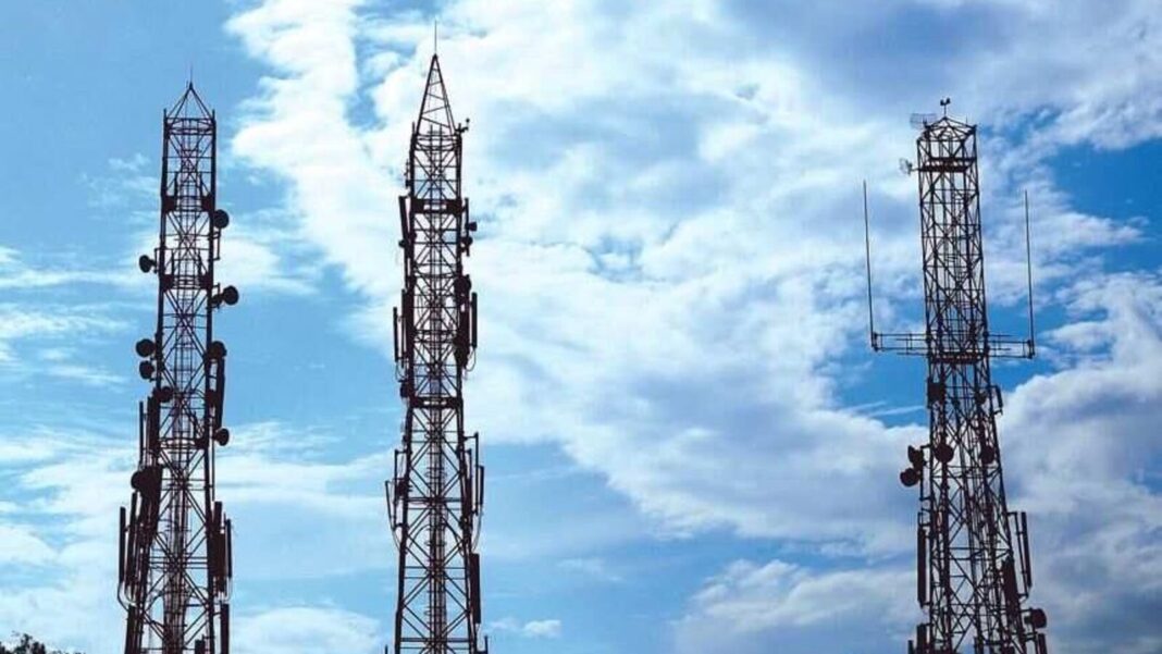 Cellular towers against cloudy sky.