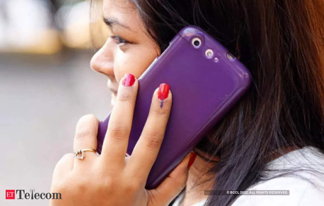 Woman talking on purple smartphone with red nail polish.