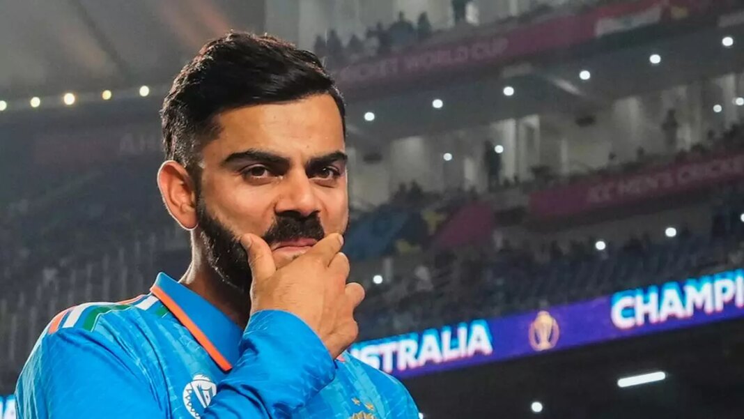 Cricketer pondering during a nighttime match.