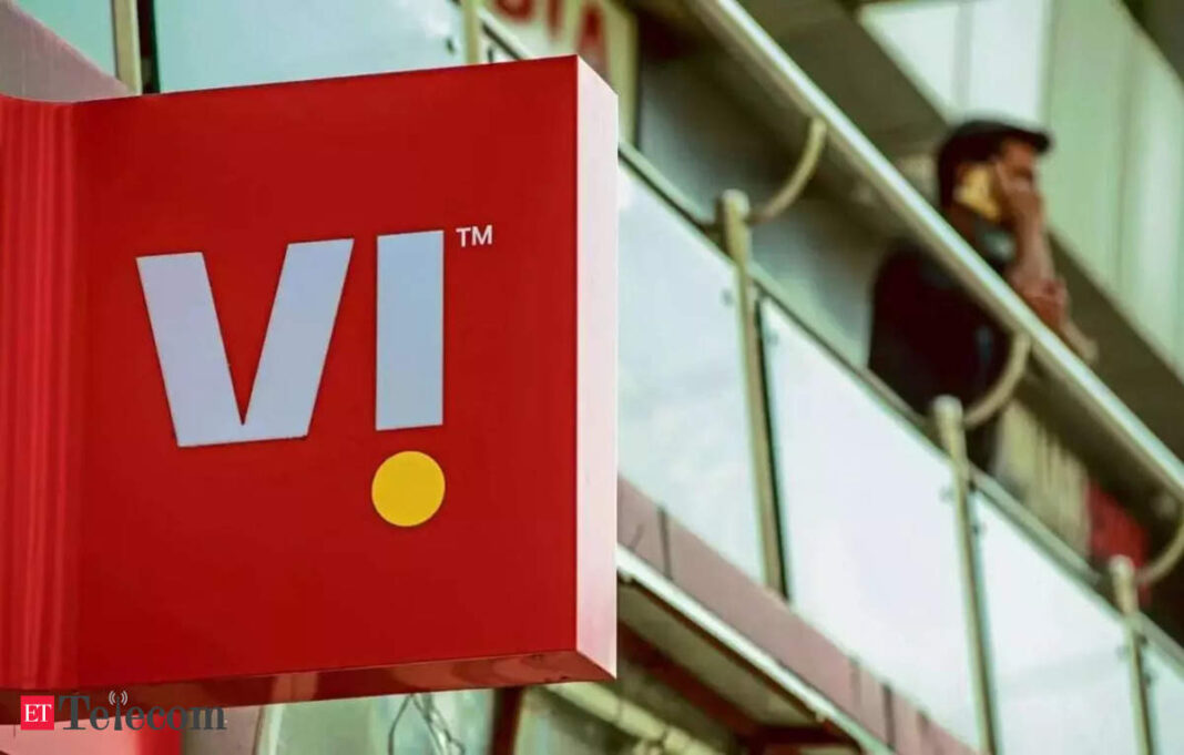 VI brand logo on storefront with person using phone.