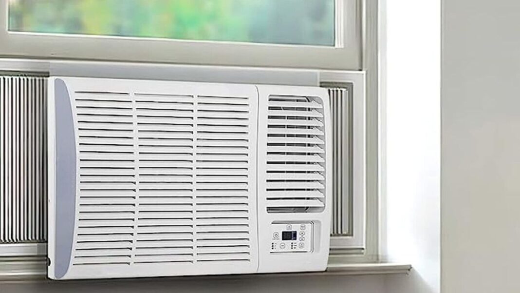 Window air conditioner installed in room.