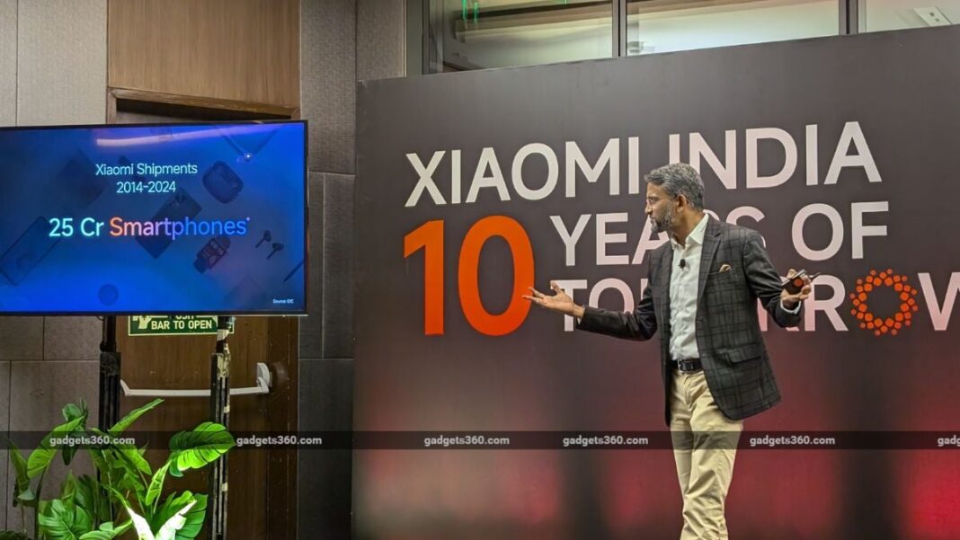 Man presenting Xiaomi's 10-year growth milestone.