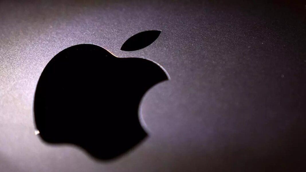Apple logo on dark reflective surface.