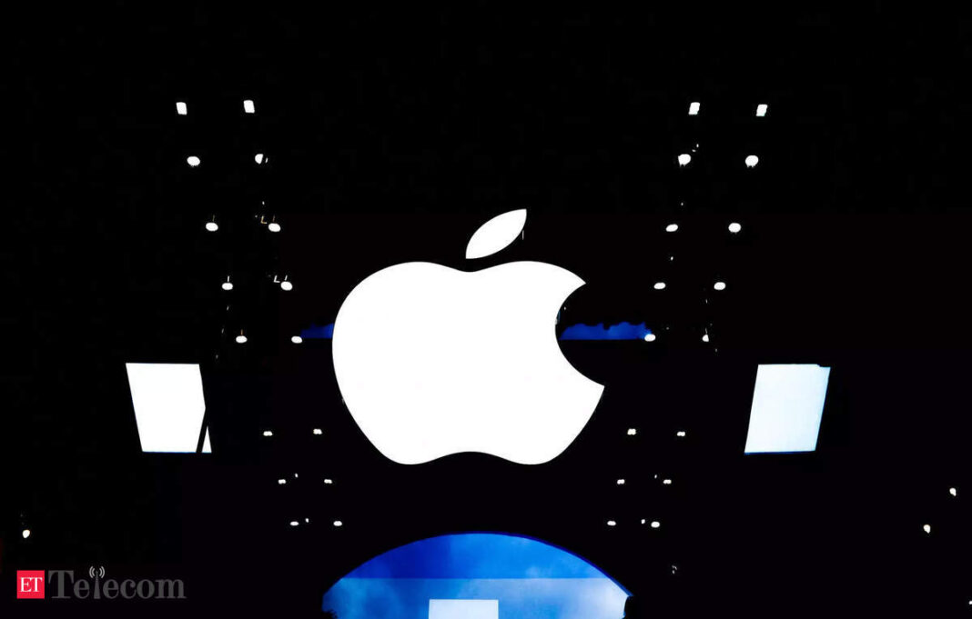 Apple logo with glowing outline at night.