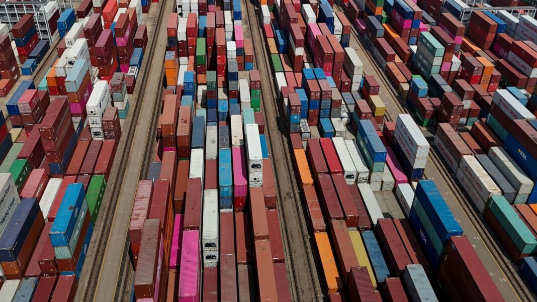 Aerial view of colorful shipping containers at port.