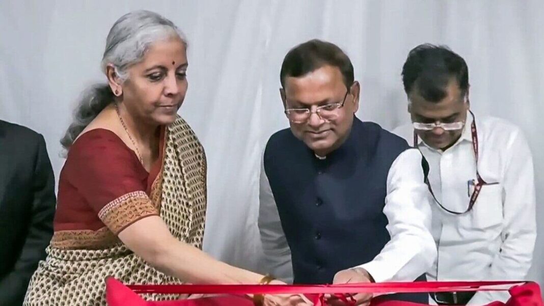 Ribbon-cutting ceremony with attendees indoors.