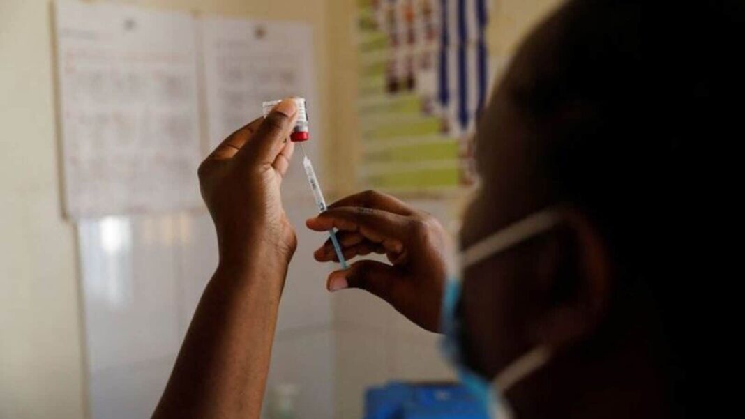 Healthcare worker preparing vaccine shot.