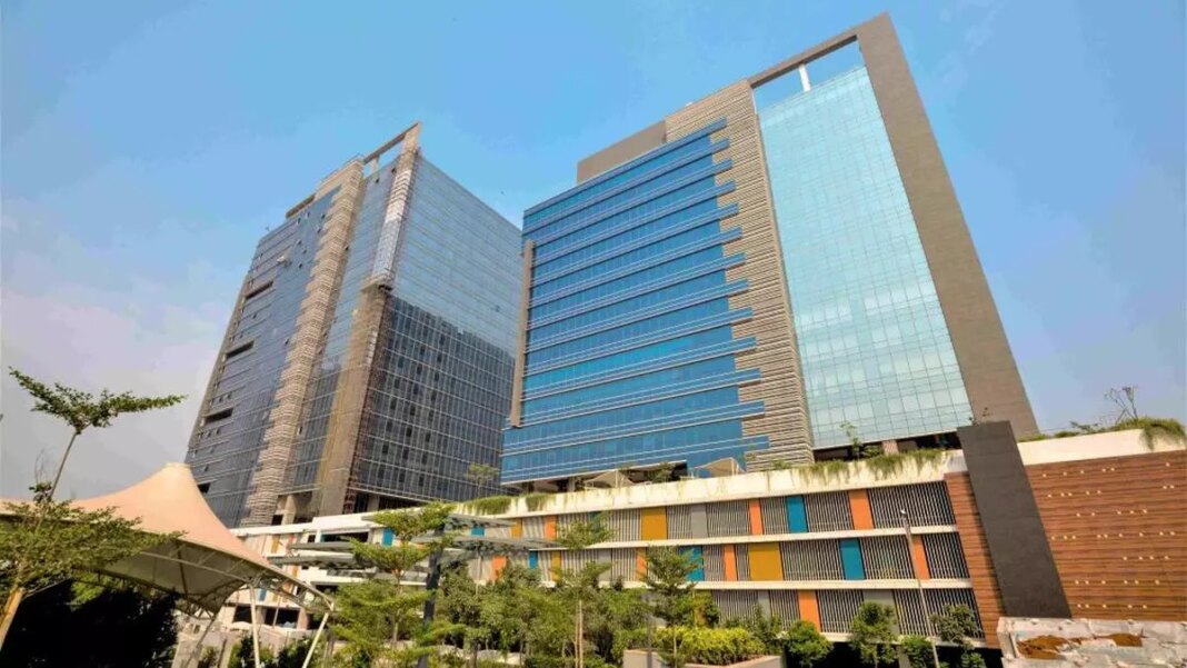 Modern glass office buildings with clear blue sky.