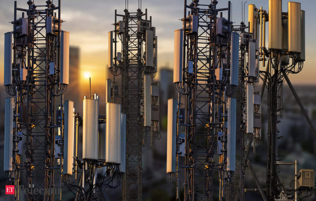 Cell towers silhouetted against sunset sky.