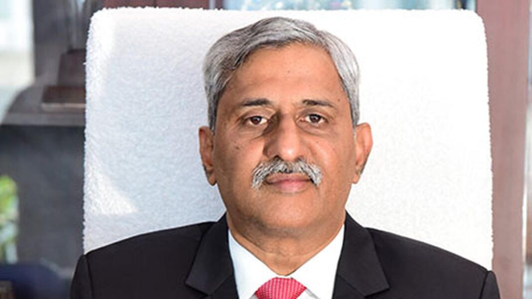 Senior man in suit with grey hair and mustache.