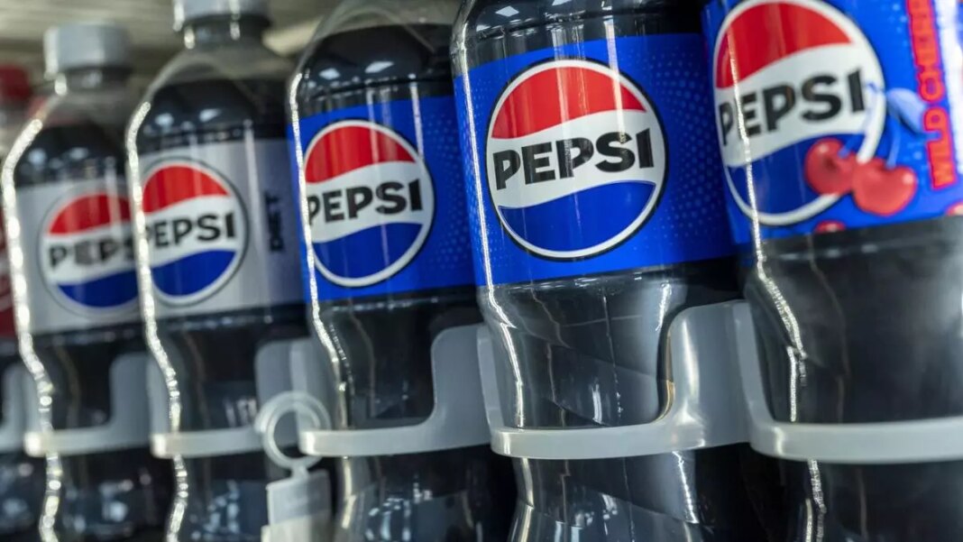 Rows of Pepsi bottles on a shelf.