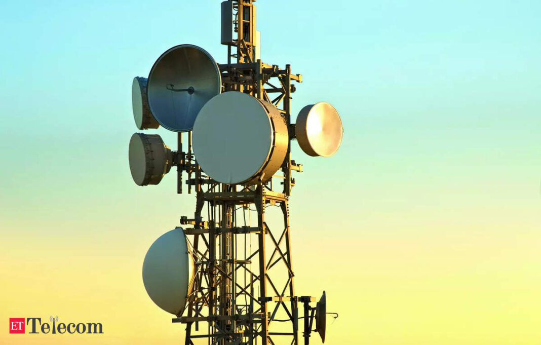 Telecommunication tower with antennas at sunset.