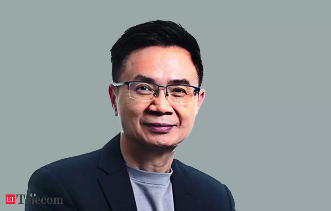 Man in glasses with confident smile, professional attire.