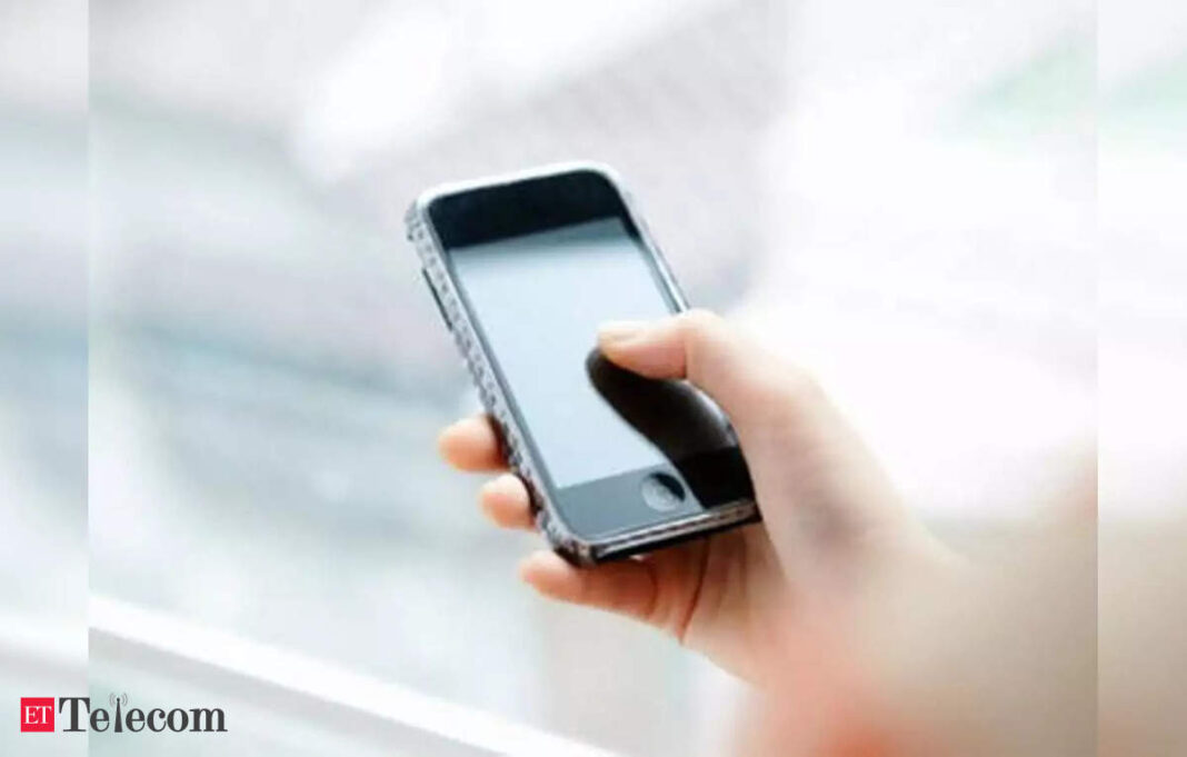 Hand holding smartphone near window