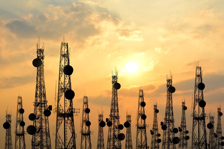 Telecommunication towers at sunset silhouette.