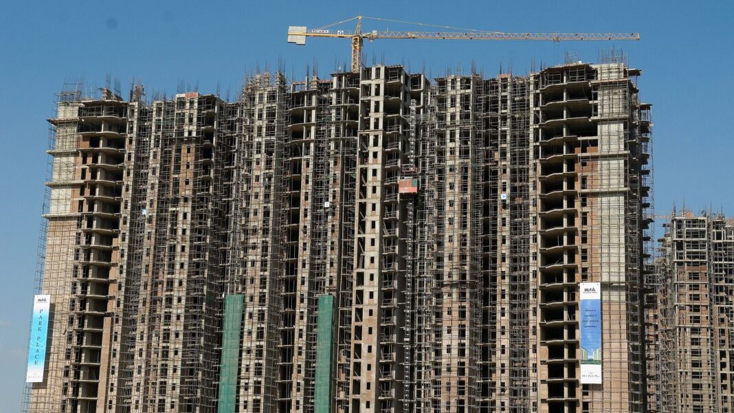 High-rise buildings under construction with crane.